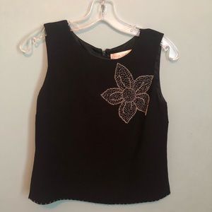 Black sleeveless top with beaded flower